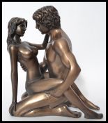 A 20th century bronze effect statuette by Kandy - depicting an erotic scene between lovers. Signed