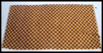 An early 20th century Tibetan polychrome chequer pattern rug . The rug decorated with red and yellow