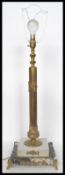 A 20th century brass table lamp having a gilt ormolu column raised on a stepped square marble