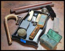 A collection of curios to include an Ivory walking stick handle, another walking stick handle,