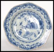 An 18th century Chinese porcelain blue and white plate, the plate decorated with domestic and