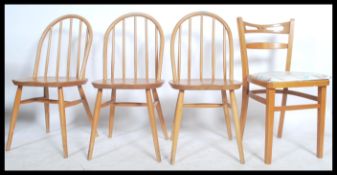 A set of three 1960's ercol light elm and beech wood hoop back dining chairs together with a mid