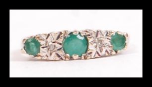 A hallmarked 9ct gold emerald and diamond gypsy set ring. Hallmarked London. Weight 2.8g. Size O.