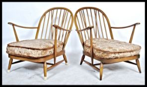 Ercol - A pair golden dawn Windsor armchairs in beech and elm, having the propeller arm rest and