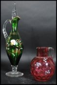 A 19th century cranberry glass jug handpainted ove