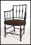 A 19th century Regency mahogany armchair having an original ebonised painted finish with remains