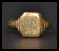 A gentleman's hallmarked 9ct gold signet ring with square panel flanked by borders with initials
