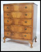 A mid century Queen Anne revival bow front mahogany bachelors chest of drawers being raised on