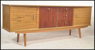 A vintage mid century sideboard raised on tapering