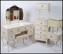 A Louis XV style cream bedroom suite to include a dressing table with a tryptych mirror, bedside