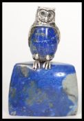 A vintage 20th century silver plated figurine of an owl mounted on a lapis lazuli base. Measures 8