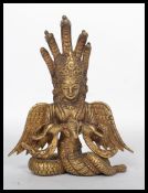 A 19th century Chinese gilt bronze Buddha having wings and snakes protruding from the back. Measures