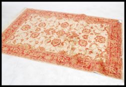 A large Persian Ziegler carpet - rug having beige ground with geometric decoration and borders.