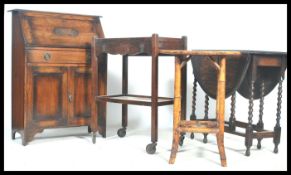 A collection of furniture to include a wooden oak trolley together with a 1920's oak student
