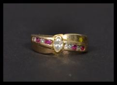 A 14ct gold white and red stone ring stamped 14k. Weighs 4.9 grams size N.5