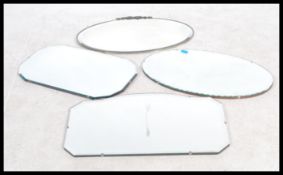 A collection of four frameless wall mirrors dating from the early 20th century to include Art Deco
