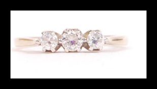 A hallmarked 9ct gold three stone ring having three white stones in prong setting. Hallmarked