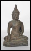 A 19th century Chinese bronze Buddha figurine modelled in the Lotus position raised on a pedestal