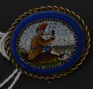 A 19th century Italian micromosaic micro mosaic and lapis lazuli brooch depicting a seated gent with