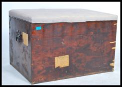 A 19th century stained pine blanket box with panelled sides having hinged top with upholstered linen
