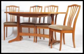 A retro 20th century Danish inspired teak wood dining table and chairs set, extendable dining