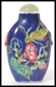 A Chinese porcelain snuff - perfume bottle with glass stopper with dabber stem. Blue ground with