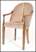 A 20th century Art Deco mahogany elbow chair havin