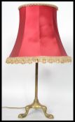 A 19th century Victorian brass tripod table lamp raised on three claw feet. Measures 55 cm high.