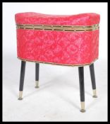 A vintage 20th century retro pink fabric work sewing box raised on four ebonised tapering legs