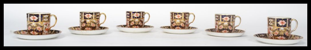 An early 20th century Royal Crown Derby six piece coffee can and saucer service / set dating to 1913