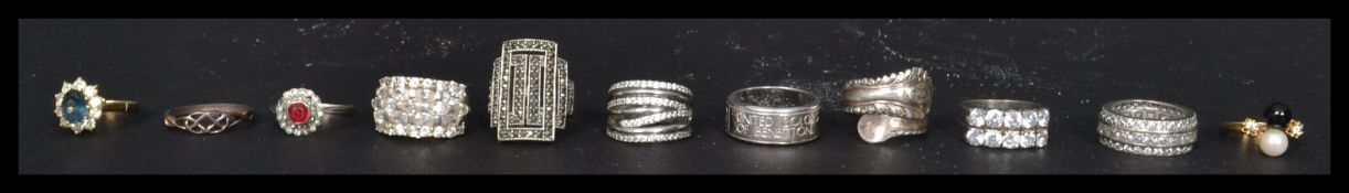 A dealers lot of silver to include 10 silver 925 rings. gilded silver sapphire ring, faux pearl