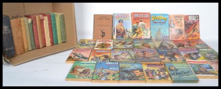 A large collection of hardback and softback books predominately Biggles, many with dust jackets,