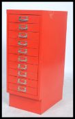 A 20th century Industrial Bisley ten drawers small filing cabinet on a plinth base in red having