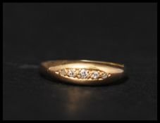 An antique 18ct gold and five stone diamond ring set with mine and rose cut graduating diamonds.