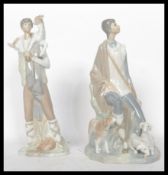 A Lladro ceramic figure group of a man holding a child, stamped to the base with impressed marks