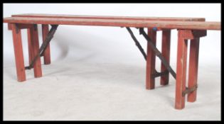 A pair of vintage 20th century Industrial heavy planked wooden folding benches - school - factory.