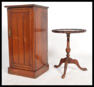 An Edwardian walnut pot cupboard / bedside cabinet raised on a square plinth base with slatted