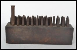 A collection of vintage industrial  20th century letter and number punches all stored within