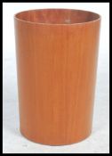 A 1960's mid century retro teak wood cylinder waste paper bin being stamped to the underside with