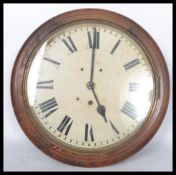 A 19th century Victorian oak cased wall mounted station / school  clock having a white enamel face