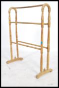 An early 20th century Beech wood towel rail raised on turned supports and rails. Measures: 82cm high