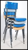 A set of four retro style stacking dining chairs, raised on chrome frames with each seat pad