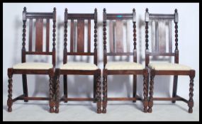 A set of 4 1920's oak barleytwist dining chairs. Raised on barley twist legs united by stretchers