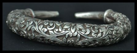 A Chinese silver bangle bracelet having an engraved foliage design. Weighs 47 grams.