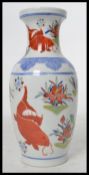A 20th century Chinese vase decorated with scenes of carp and weeds with ochre red character marks