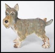 A vintage 20th century painted cast iron novelty doorstop figurine in the form of a urinating
