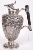 A stunning 19th century silver plated Claret Jug of urn form raised on a pedestal foot, heavily