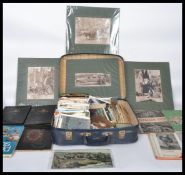 Suitcase with miscellany of unsorted postcards, stamps, ephemera, photos.