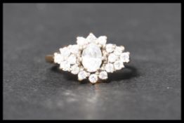 A hallmarked 9ct gold and CZ cluster ring . Hallma