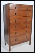 A 1930's Art Deco oak chest of drawers having, six graduating drawers fitted with drop handles and